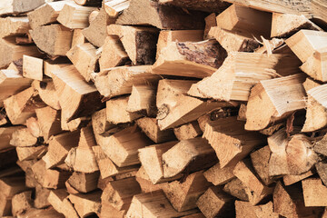 Closeup stack of dried fuel wood or firewood, natural wood background