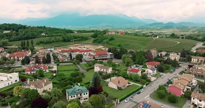 Aerial View of Cornuda, Italy: Urban Landscape with Architectural Houses in Mountainous Cityscape. High quality 4k footage