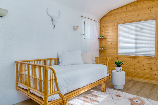 Rattan daybed boho cabin bungalow knotty pine paneling