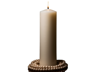 a white candle with a pearl necklace around it