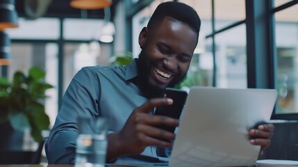 Obraz premium Black man smile and laptop in office with smartphone for web design online project and social media Business person corporate and happy working on digital tech for research planning an : Generative AI