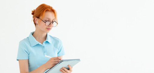 Pensive dreamy thoughtful caucasian young woman using digital tablet for distant work, freelance job, creative occupation, having idea startup isolated in white background