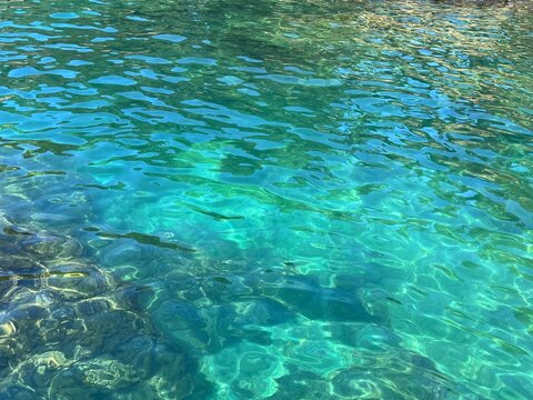Clear sea water glittering turquoise blue surface