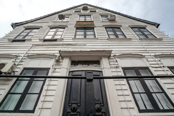 Old  white wooden house with the flag of Suriname on it's facade, historical center of Paramaribo, Suriname, South America