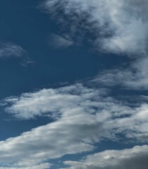 Obraz premium The Sky is a Vast Expanse of Blue with Fluffy White Clouds Floating in it, Creating a Picturesque Scene of Natural Beauty and Tranquility