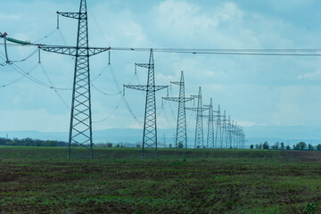 High voltage towers with sky background. Power line support with wires for electricity...
