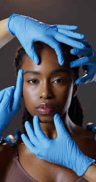 Hands, skincare and plastic surgery portrait of black woman in studio for beauty, confidence or facial care. Dermatology, facelift and girl in surgical gloves, cosmetic treatment and dark background.