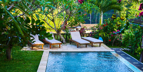 Outdoor luxury swimming pool at the holiday. Beautiful relax place. Summer day lifestyle relax near luxury swimming pool sunbath at the beach resort in the hotel.