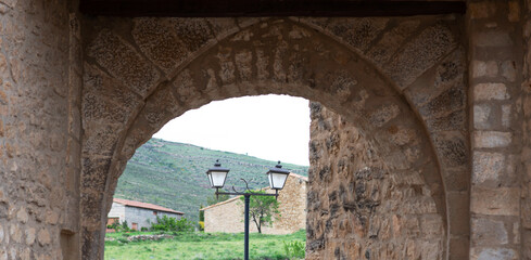 Fototapeta premium Vintage stone houses in picturesque medieval town. Old charming streets. Typical village with stone facades. Architecture and sights of Spain.