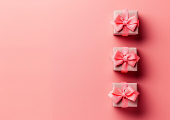 pink gift boxes with bows on a pastel background, in a flat lay.Minimal creative party concept.