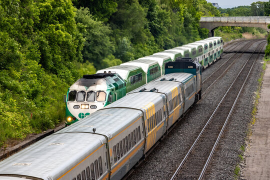 Toronto Canada, June 10 2024; VIA Rail commuter train and GO Transit commuter trains passing each other in Scarborough
