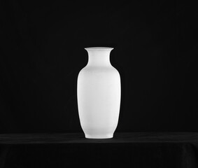 white classic vase, clay jug on a black background