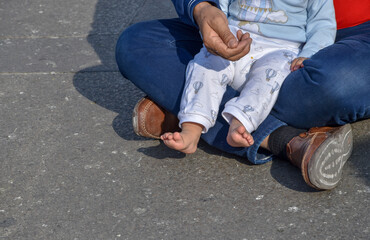 A man begs for money with a baby on the street. Beggars. Human trafficking. Using children to beg...
