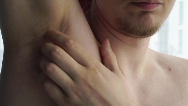 men's armpit.
Man scratching his armpit