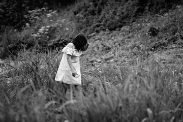 Portrait of a young beautiful dark-haired girl. Black and white photo.