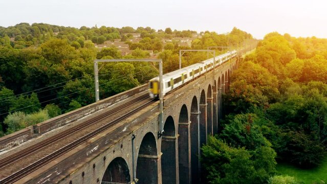 Aerial view train travelling through English countryside. A British Rail Train. 