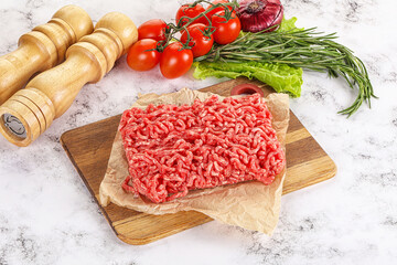 Raw minced beef meat on cutting board