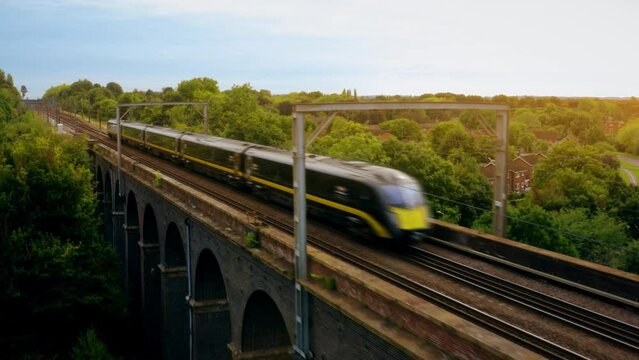 Aerial of a train riving over The Ouse Valley Viaduct across the river Ouse in Sussex England. 