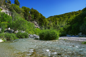 Alcantara Gorge and Alcantara river Park in Sicily, Italy. Water and Volcanic stones wall.