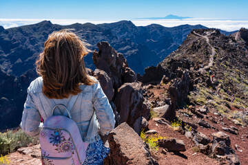 Woman with her back turned contemplating the breathtaking views of the Canarian landscape, La Palma.