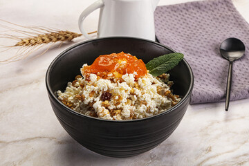 Curd with granola and orange jam