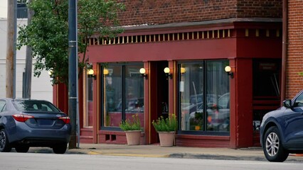 A dusk evening establishing shot of a New England small-town storefront, perhaps selling one of a kind gifts and trinkets. Blank sign for customization.  	