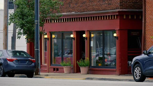 A dusk evening establishing shot of a New England small-town storefront, perhaps selling one of a kind gifts and trinkets. Blank sign for customization.  	