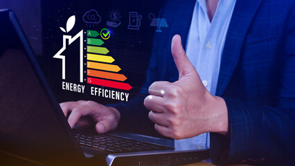 Energy efficiency concept, Businessman touching virtual screen of energy efficiency rating for...