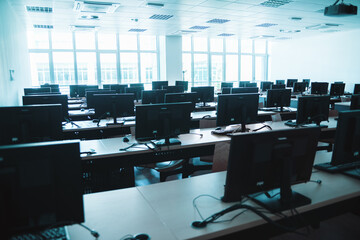 Empty lab with monitors, keyboards, bright windows
