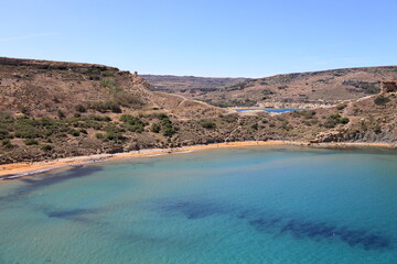 Ghajn Tuffieha Bay in Malta also known as Riviera Bay or Martinique Bay. It is located on close to a village Manikata. In English Għajn Tuffieħa means Apple’s Eye. Two hundred steps leading down to th