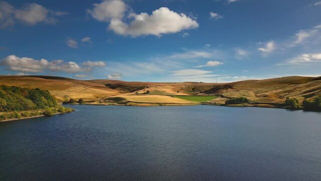 Cinematic, aerial clip of Ogden Reservoir, Oldham, on the edge of the Pennines.