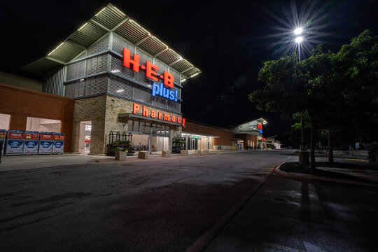 HEB plus Pharmacy and grocery store entrance with sign illuminated at night, Blue Rhino Propane, Bulverde, Spring Branch, Texas