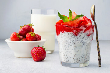 Chia pudding made from yogurt, chia seeds and strawberries on a light background, horizontal. Useful, healthy eating, diet, self-care. A healthy, easy dessert for breakfast.
