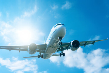 Obraz premium Airplane taking off on sunny day with blue sky