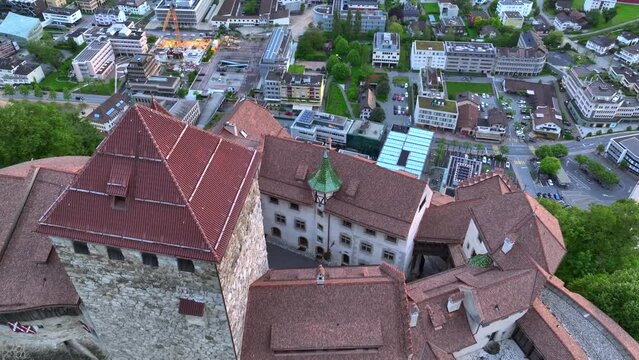 Vaduz Castle in Liechtenstein. Picturesque view of fairytale castle in Alps mountains at Sunset Time. A Landmark Aerial