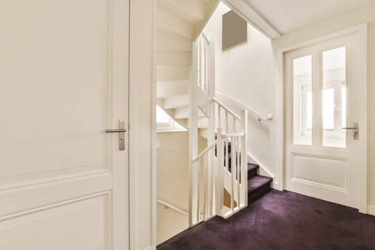 A stairwell in a home with a white door