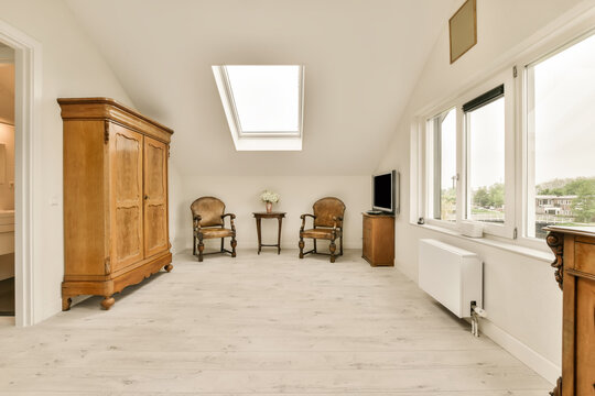 A living room with wooden furniture and a large window