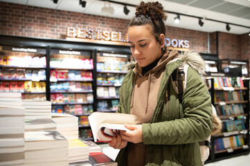 Young woman browsing books in a bookstore