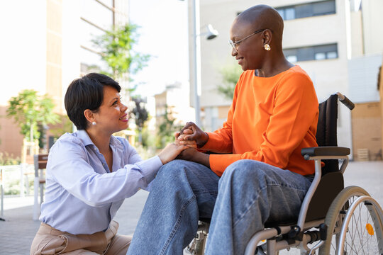 Business discussion between two diverse women, one in wheelchair