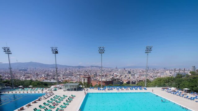 iew of barcelona olympic swimming pool and city skyline behind 