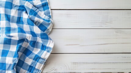 Blue checkered tablecloth on white wooden planks with copyspace for your product or text