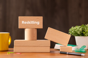There is wood block with the word Reskilling. It is as an eye-catching image.