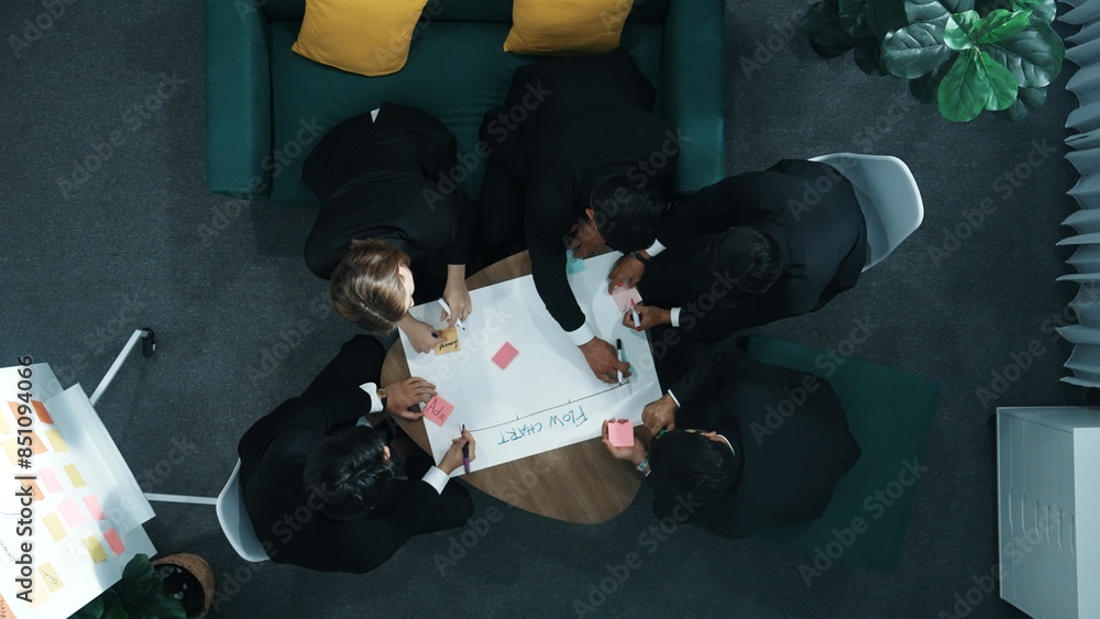 Poster close up of professional business team hands writing and putting sticky note on scrum task board. to