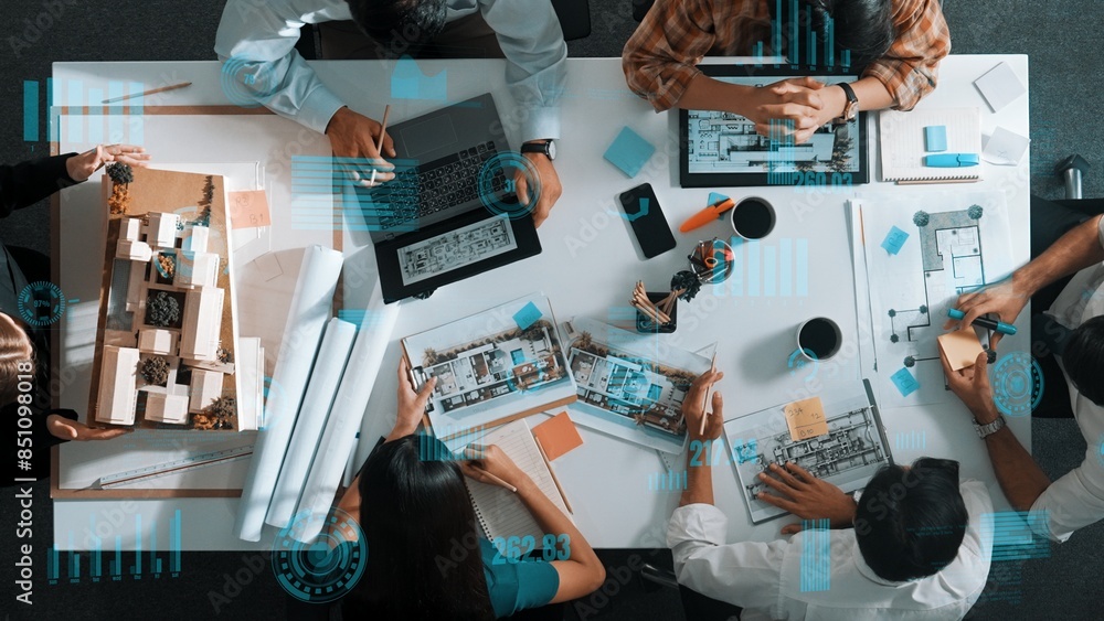 Aufkleber top down aerial view of team looking at blueprint and talking about financial chart or investment st