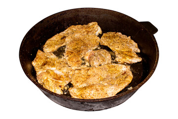 Fried meat in a frying pan.Roast pork in a frying pan on a white background.Pieces of fried meat.