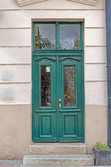 Retro closed wooden entrance door outside with stone wall facade