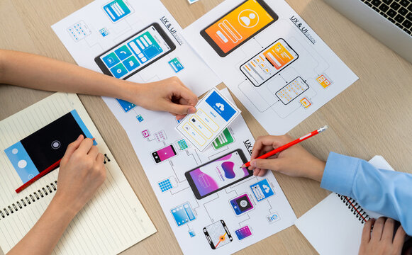 Panorama banner of startup company employee planning on user interface prototype for mobile application or website in office. UX UI designer brainstorm user friendly interface plan. Synergic