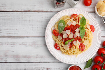 Tasty pasta with tomato sauce and ingredients on white wooden table, flat lay. Space for text
