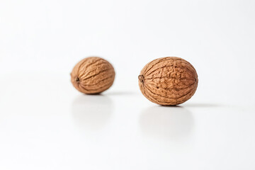 Two Whole Walnuts on a White Background