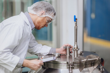 Scientist staff working with Equipment in Science Lab. Medical factory staff. Pharmaceutical Plants Process.